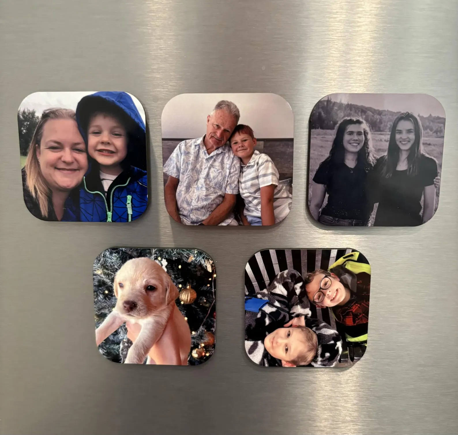 Five custom 2.5 inch photo magnets on a fridge